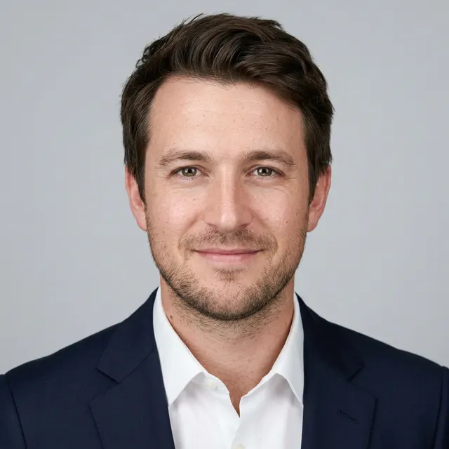 Corporate headshot of the same AI-generated example person