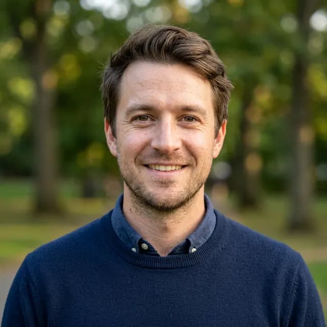 Outdoor headshot of the same AI-generated example person